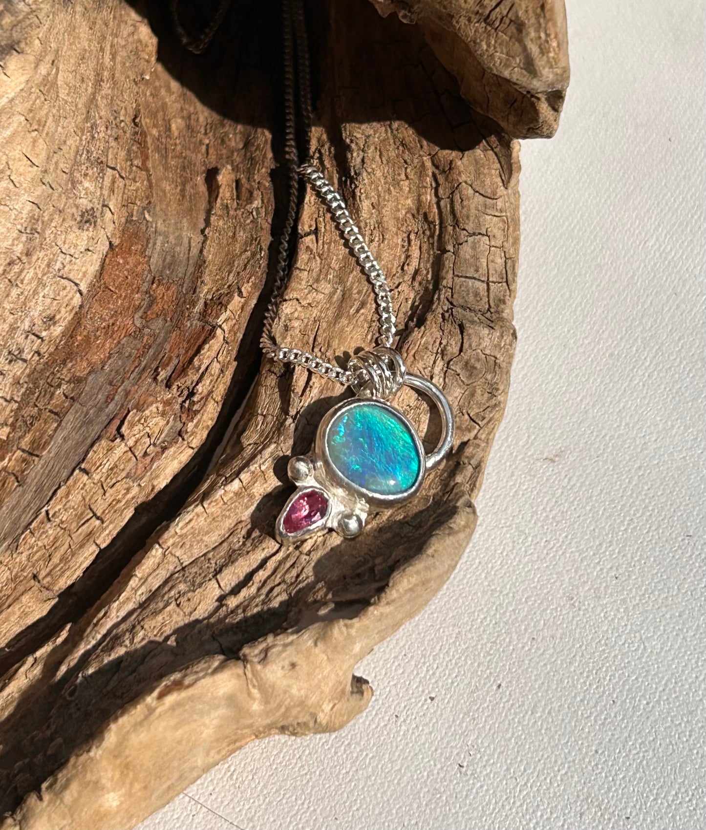 Opal and tourmaline pendant available